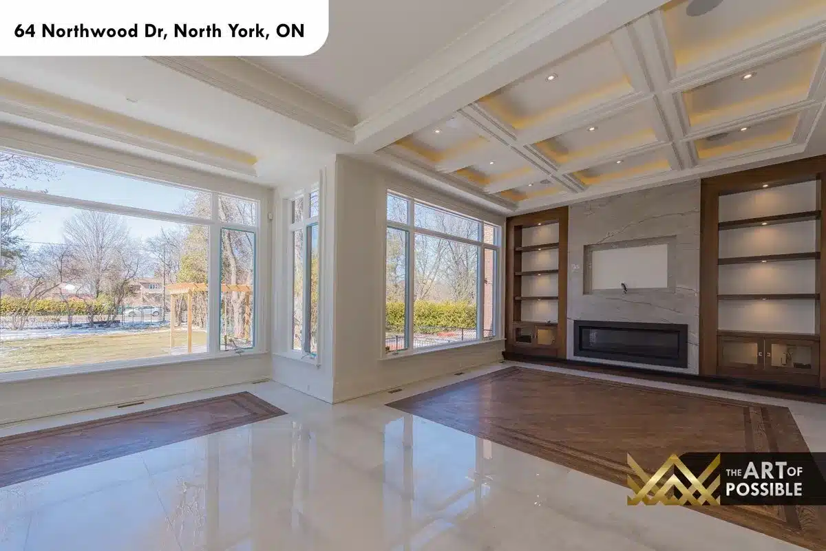 Family room with coffered tray ceiling and marble fireplace wall