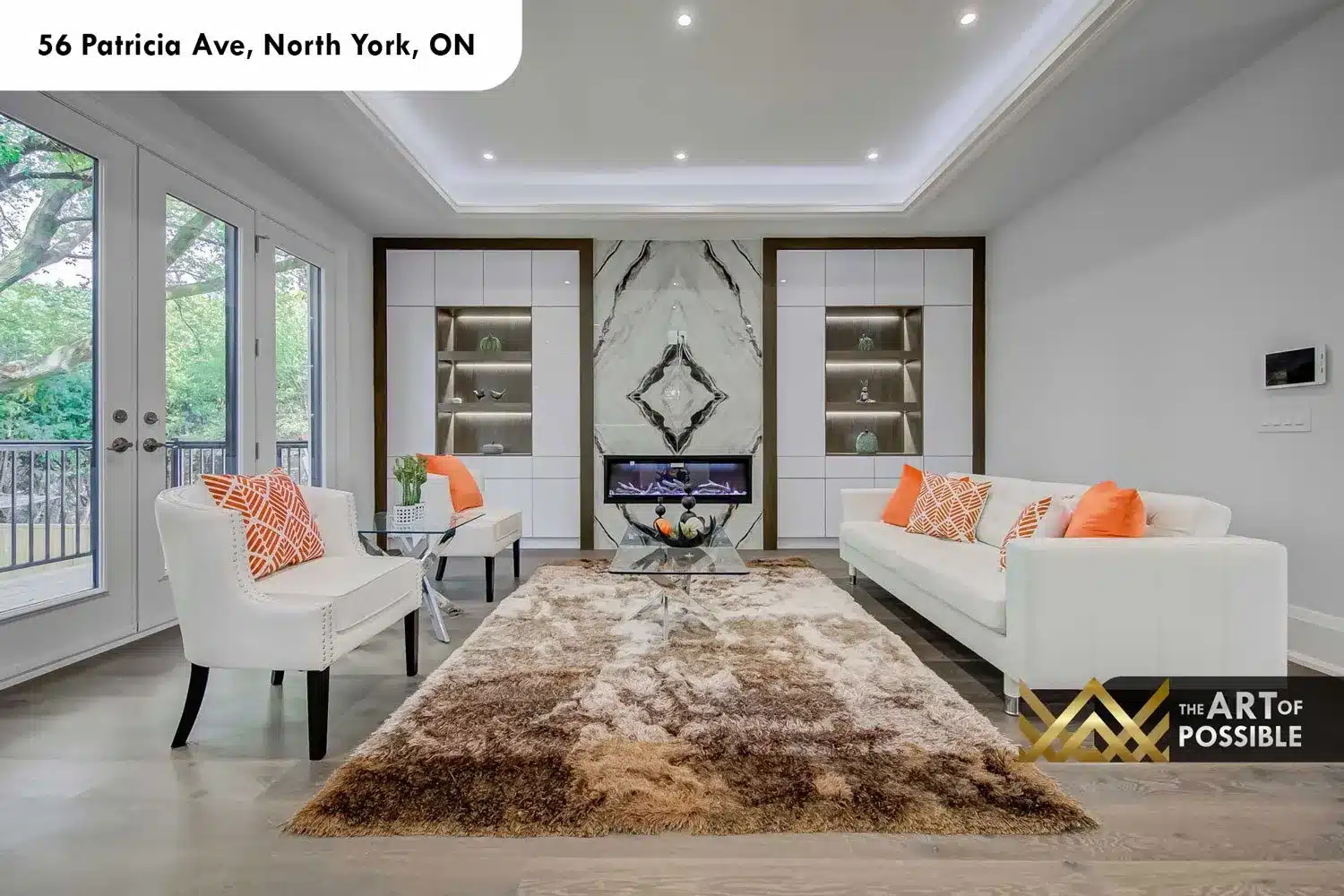 Family room at 56 Patricia Ave with book-matched marble fireplace and built-in cabinetry