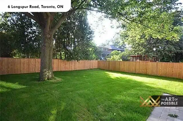 Deep fenced backyard with mature trees and lush lawn at 6 Longspur Rd Toronto