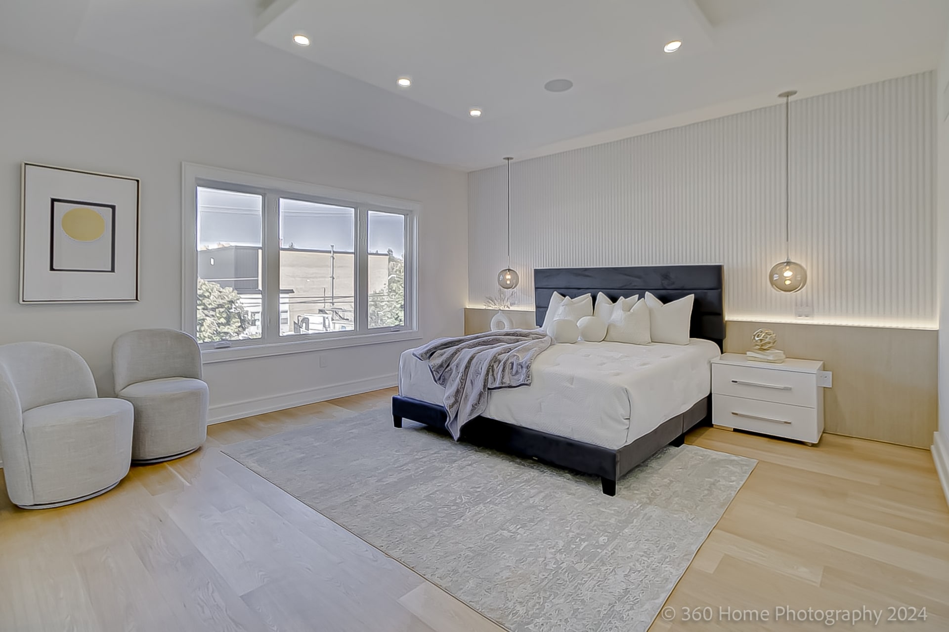 Primary bedroom at 100 Glenvale Blvd with reeded white panel accent wall and globe pendant lights