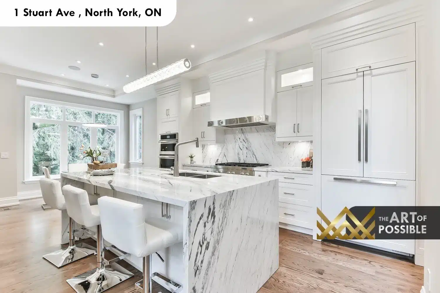 1 Stuart Ave marble waterfall kitchen white shaker cabinetry linear pendants