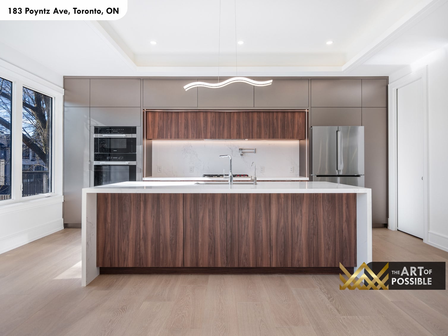 183 Poyntz Ave North York kitchen with walnut cabinetry marble waterfall island wave pendant light and Miele appliances