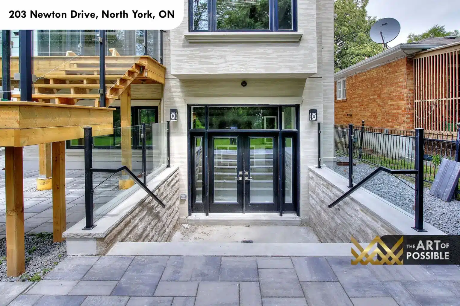 Walkout lower level entry with glass double doors under the deck