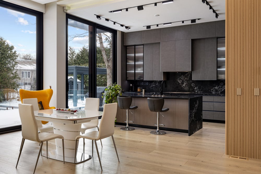Open-plan dining and kitchen at 27 Farr Ave showing reeded oak partition column and rear yard views