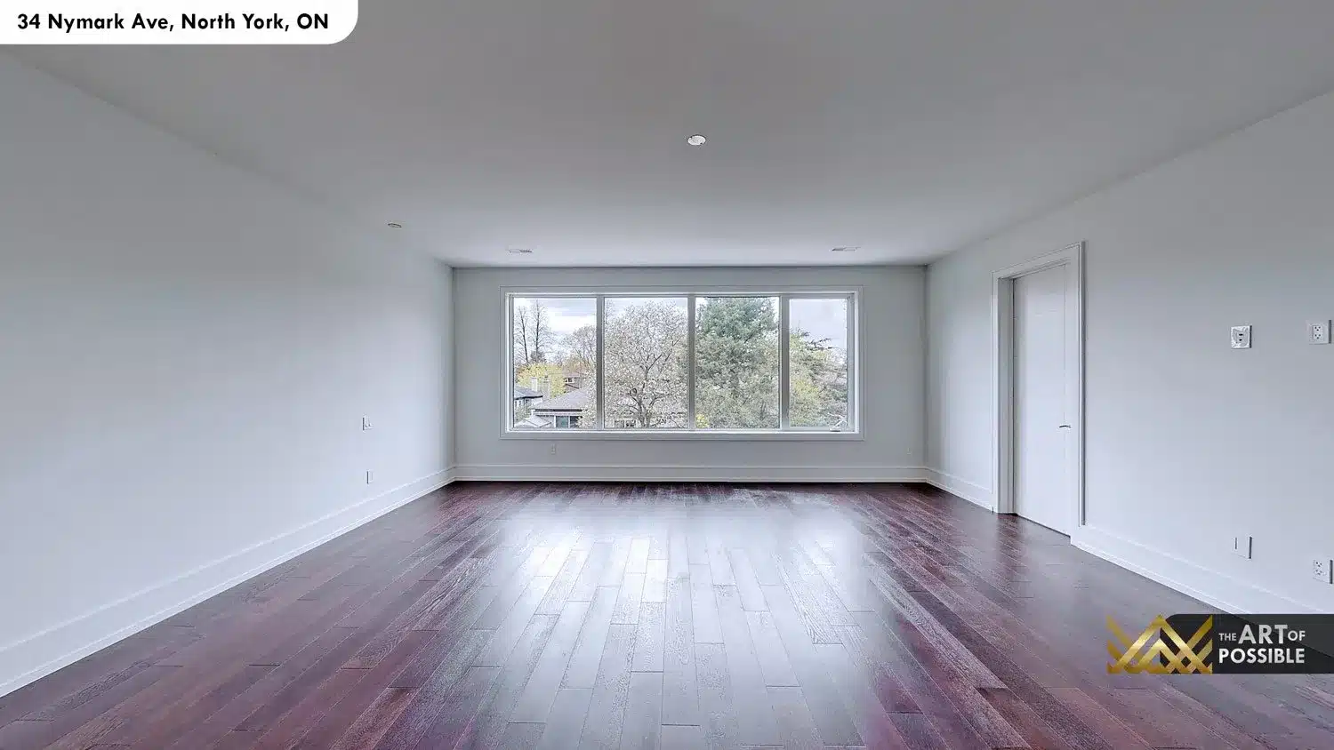 Secondary bedroom on upper floor - dark espresso hardwood and large picture window with tree views