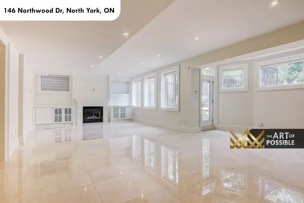 Walkout lower level recreation room with marble fireplace and white built-ins