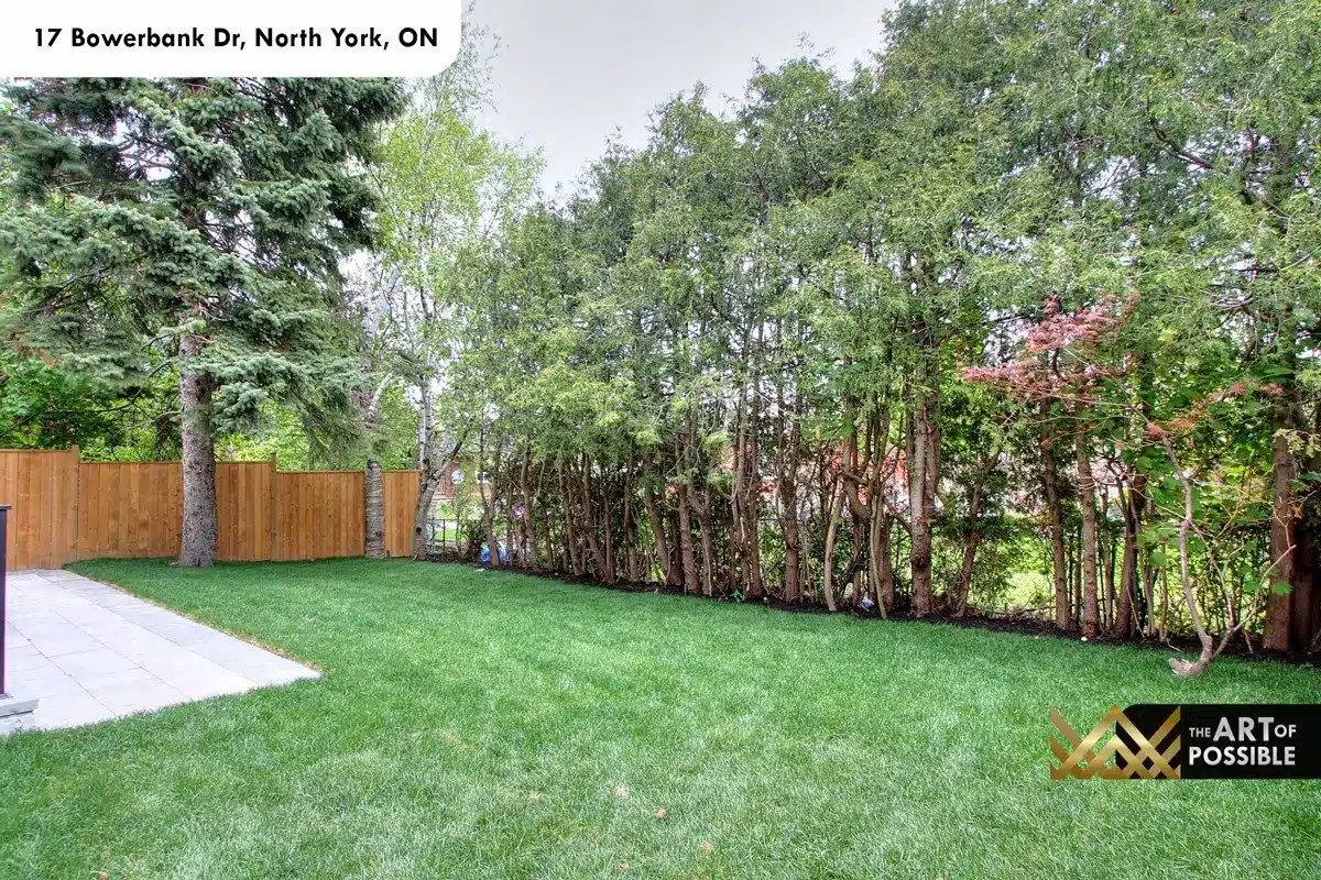 Rear yard with mature trees and privacy fencing at 17 Bowerbank Drive