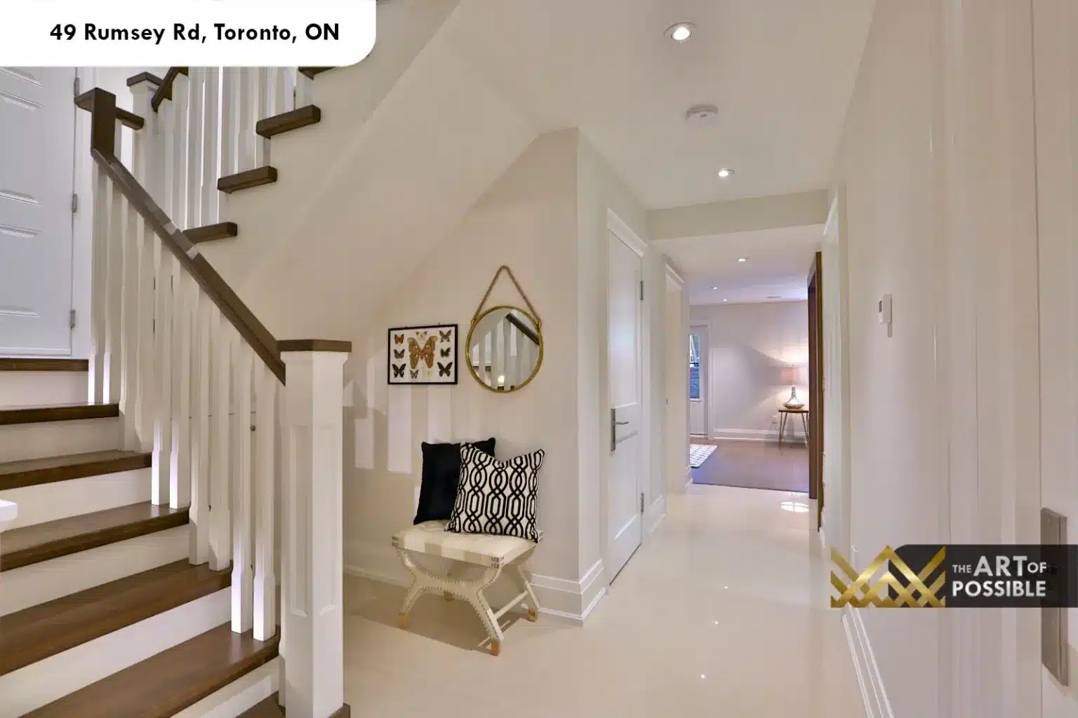 49 Rumsey Rd upper hallway staircase white spindles dark wood treads tile corridor