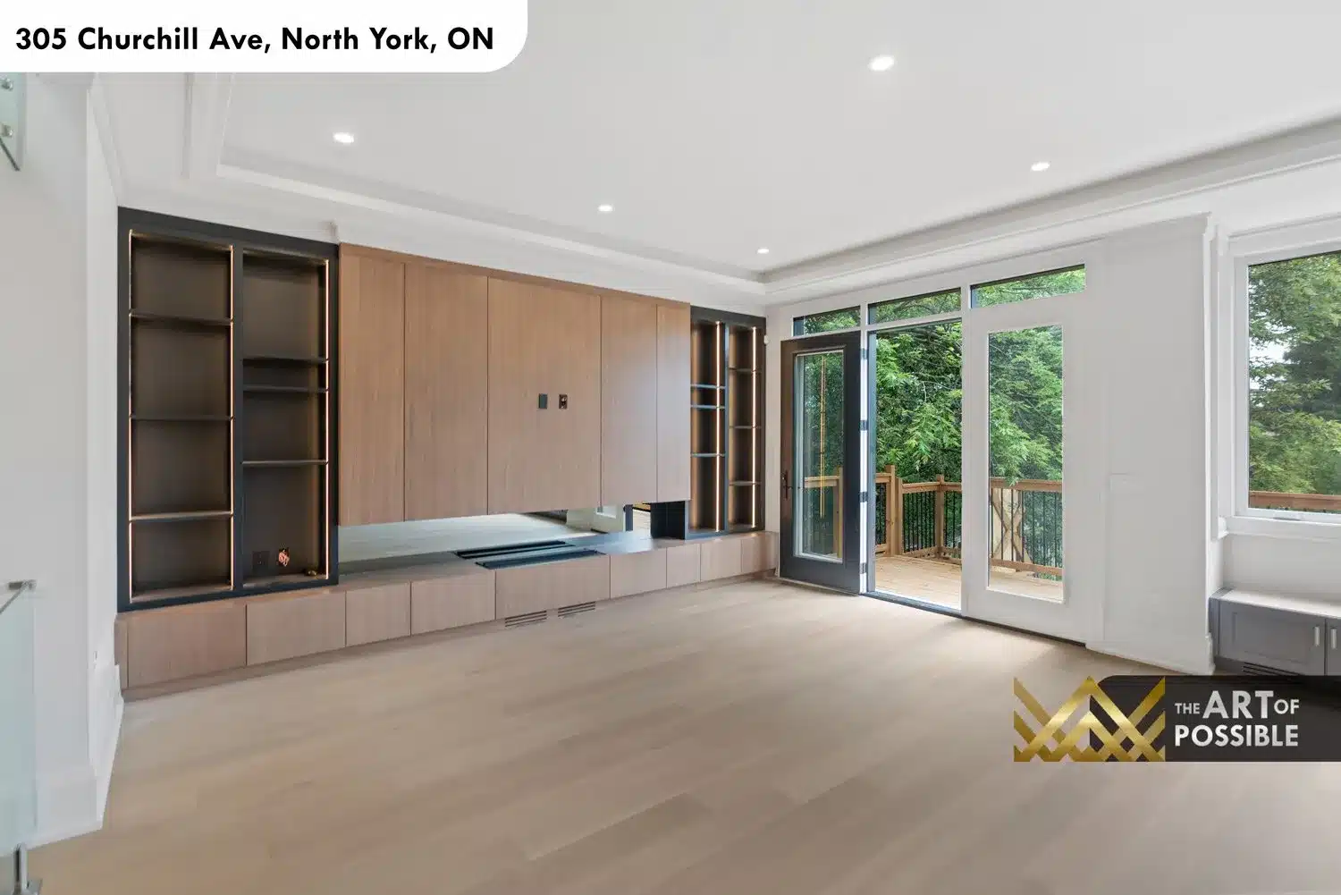 Family room entertainment built-in with LED strip lighting, tray ceiling and view to rear deck