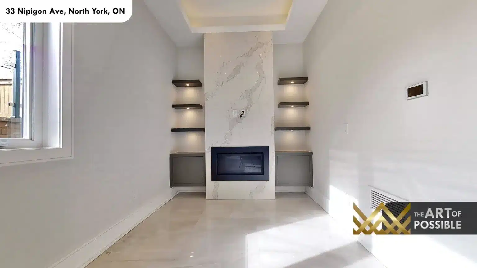 Lower level recreation room with marble fireplace surround and dark floating shelves