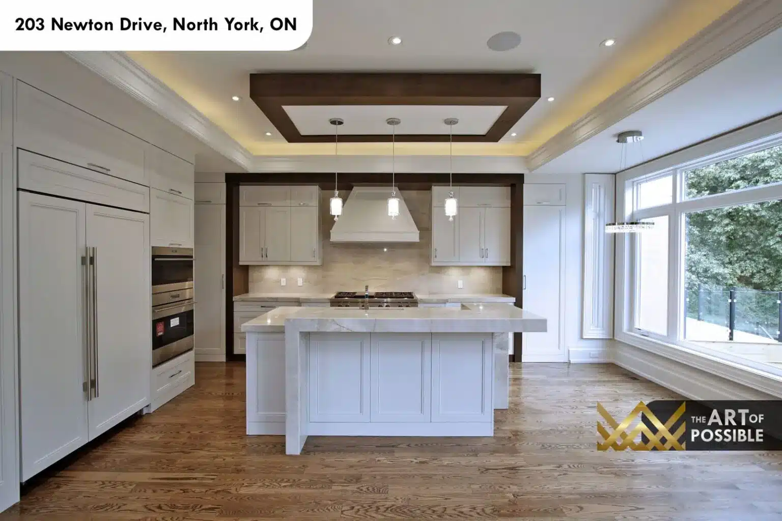 Open kitchen and family area with full-height garden windows and walkout doors