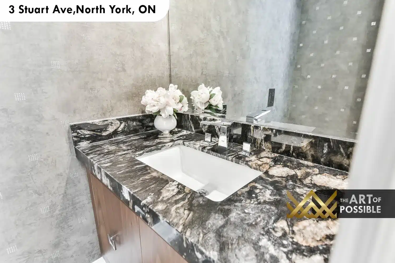 Powder room with dark veined black marble countertop, chrome wall-mount faucet and grey textured tile walls