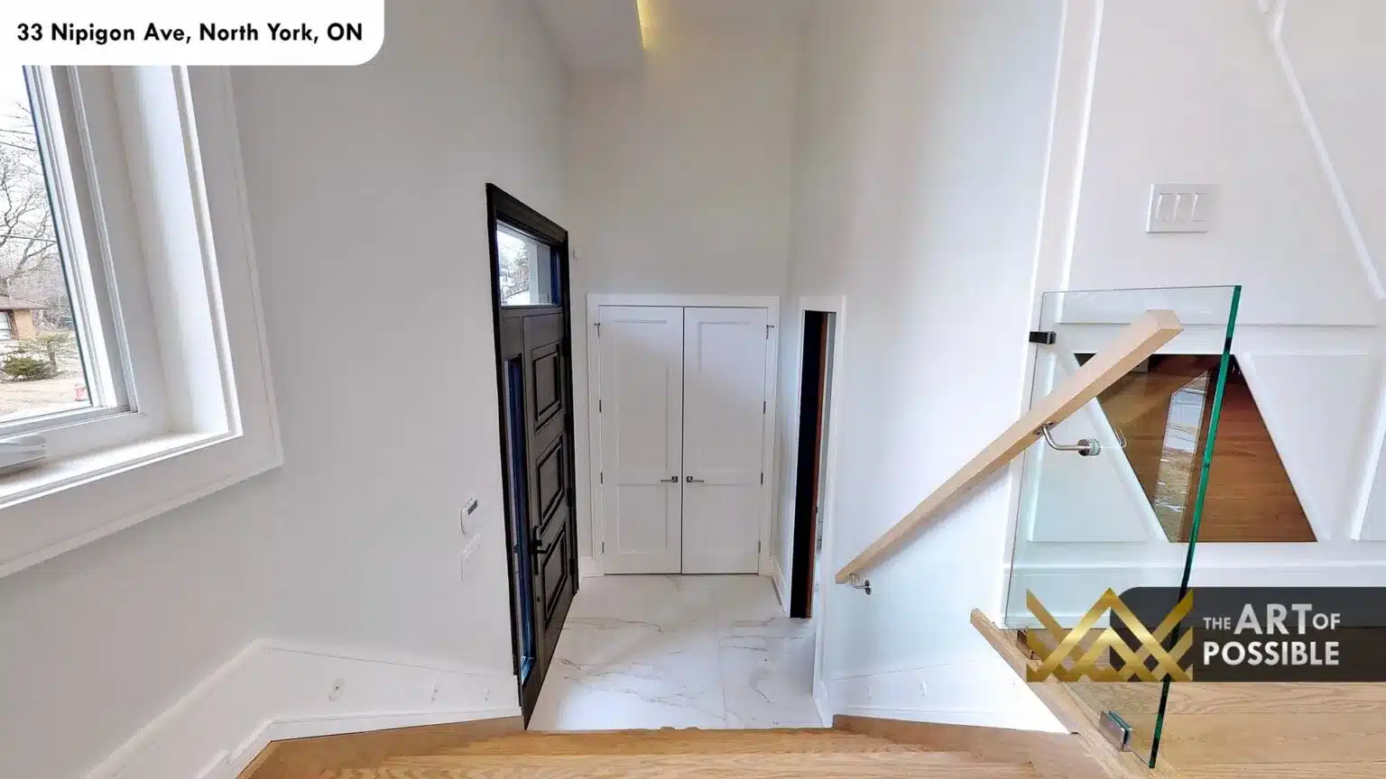 33 Nipigon Ave foyer with black front door open and white marble floors