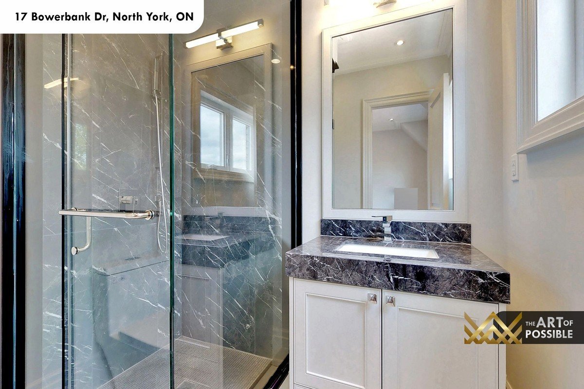 Secondary bathroom with dark marble vanity top and matching marble shower walls