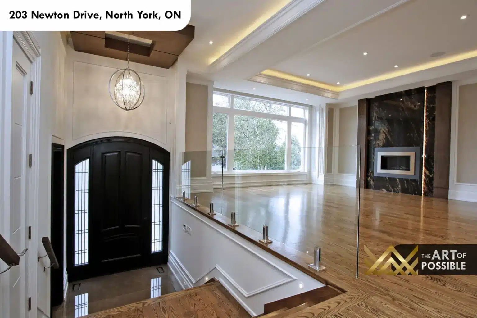 Floating oak staircase with wood handrail and glass panels