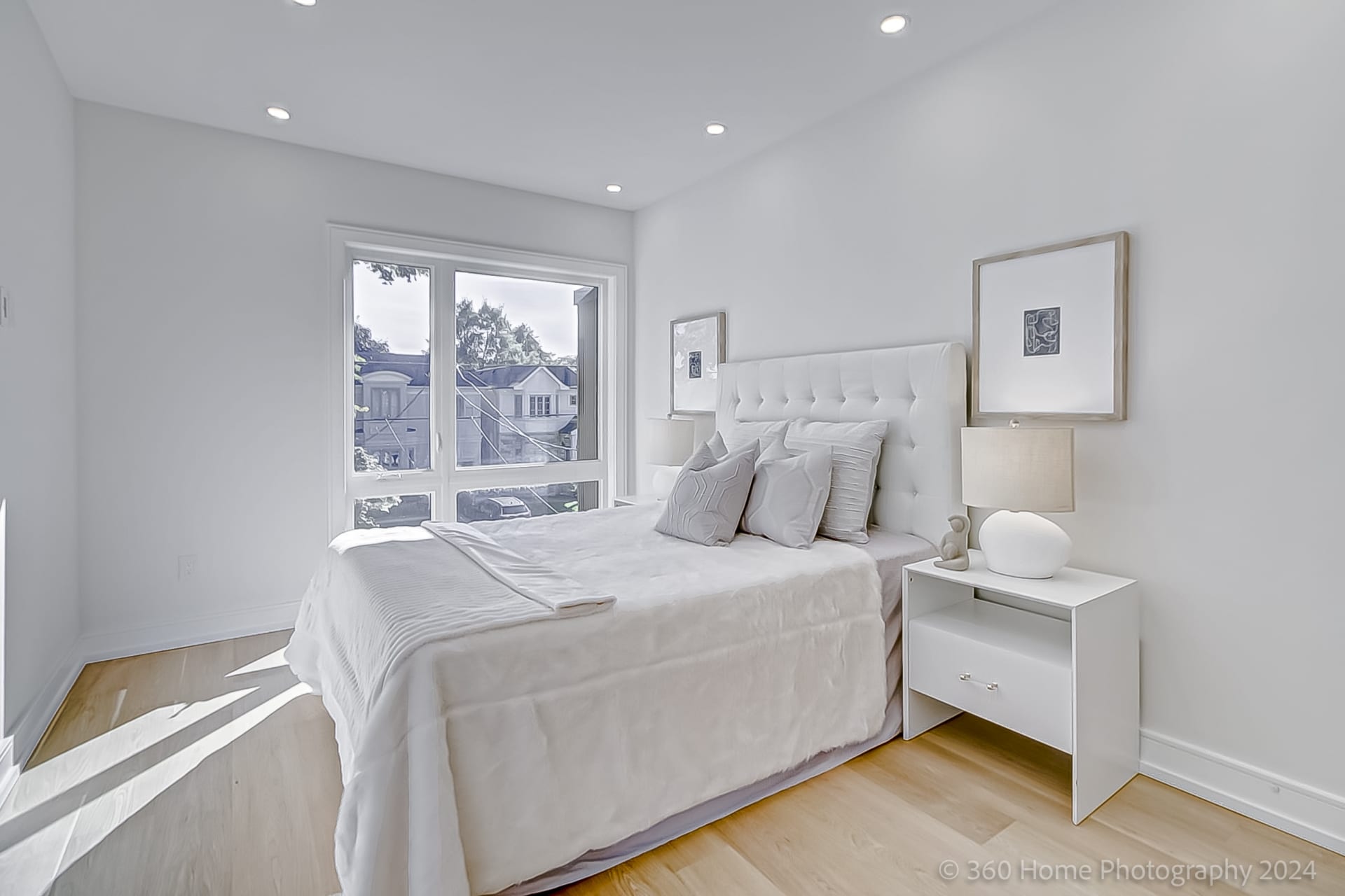 Secondary bedroom at 100 Glenvale Blvd with pale hardwood floor and large window