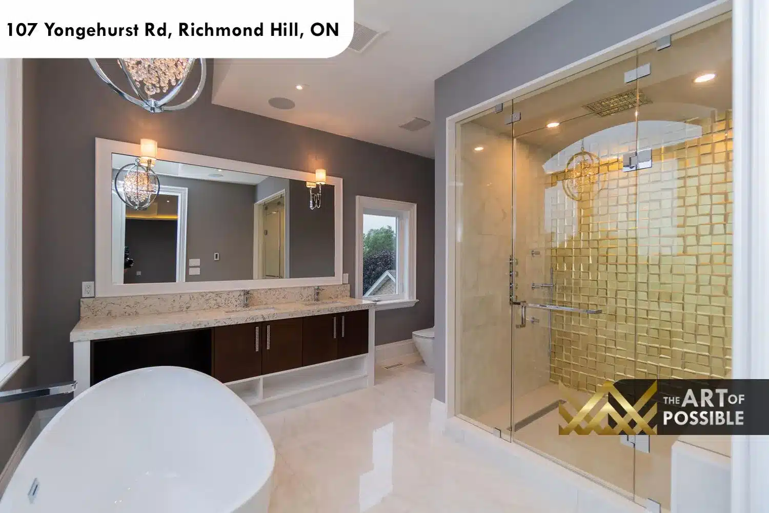 Primary ensuite shower with gold mosaic tile walls, frameless glass enclosure and chrome rain head