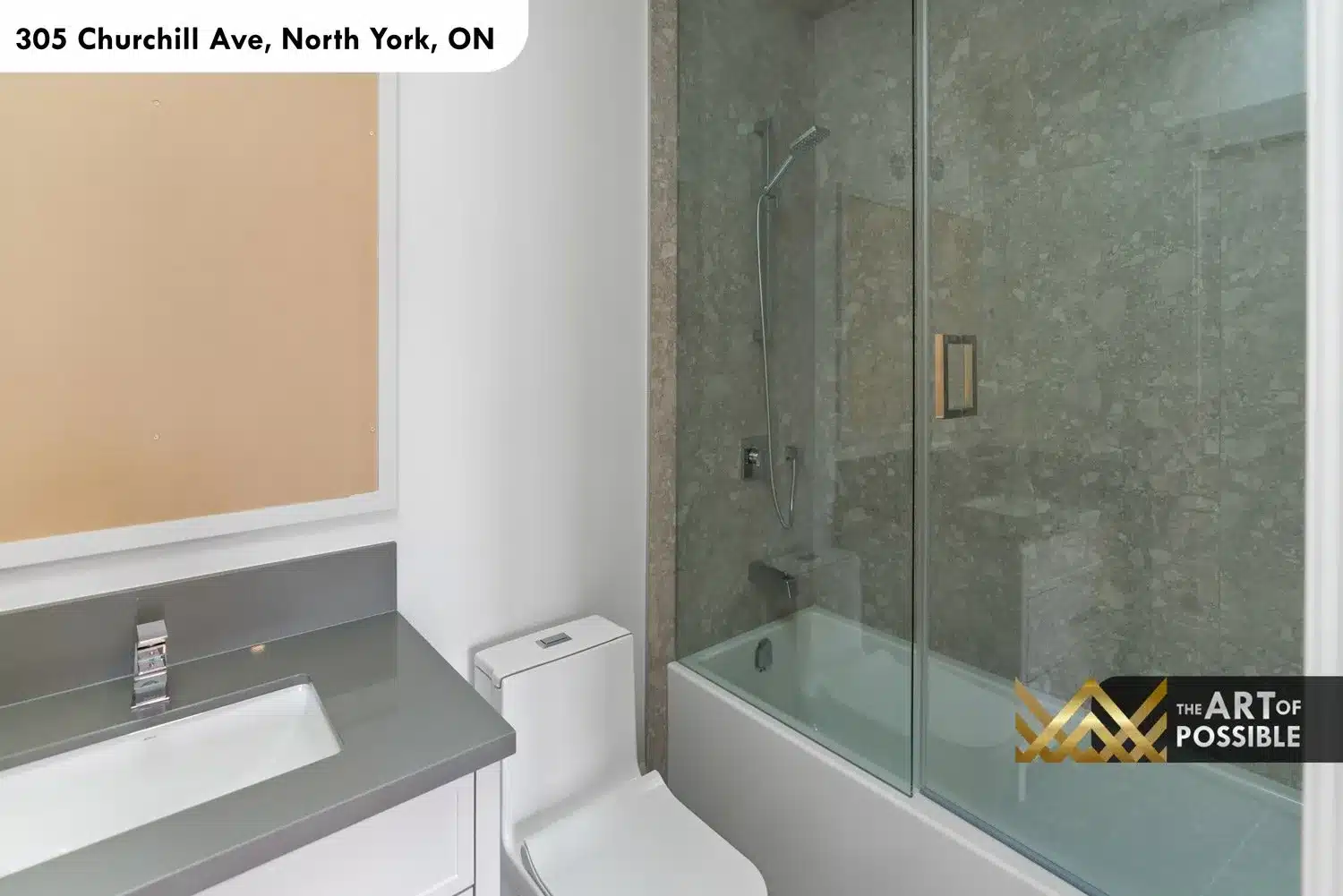 Secondary bathroom with tub and shower combo, natural aggregate stone tile surround and glass screen