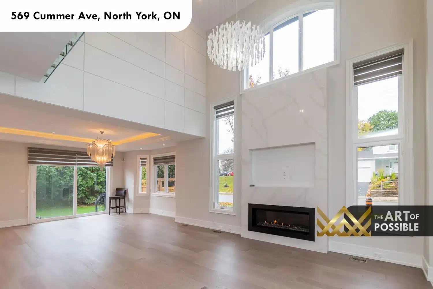 569 Cummer Ave two storey living room white marble fireplace surround linear insert glass doors