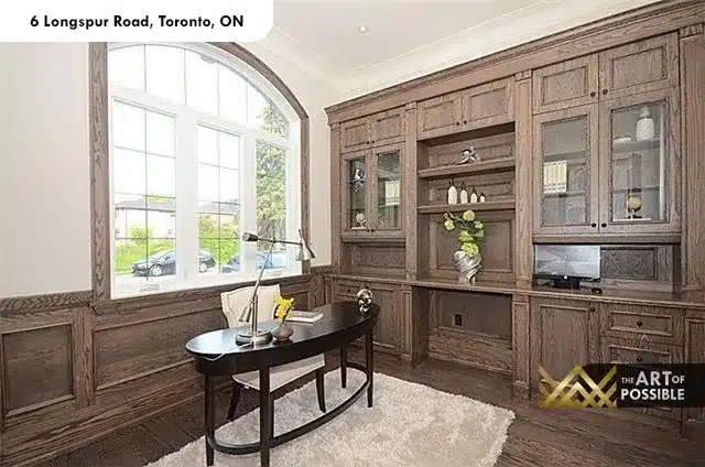 Main floor home office with full wall oak built-in cabinetry and arched window at 6 Longspur Rd Toronto