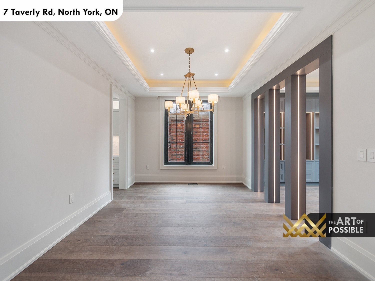 Dining room with brass chandelier and coffered tray ceiling