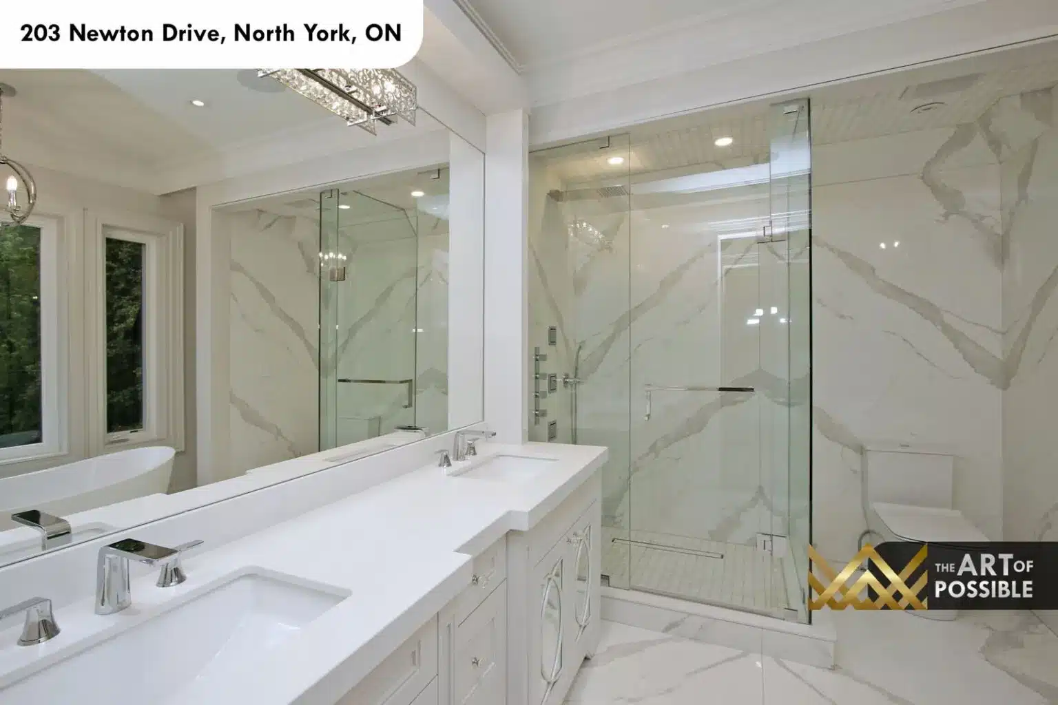 Freestanding oval soaker tub beneath windows with marble surround