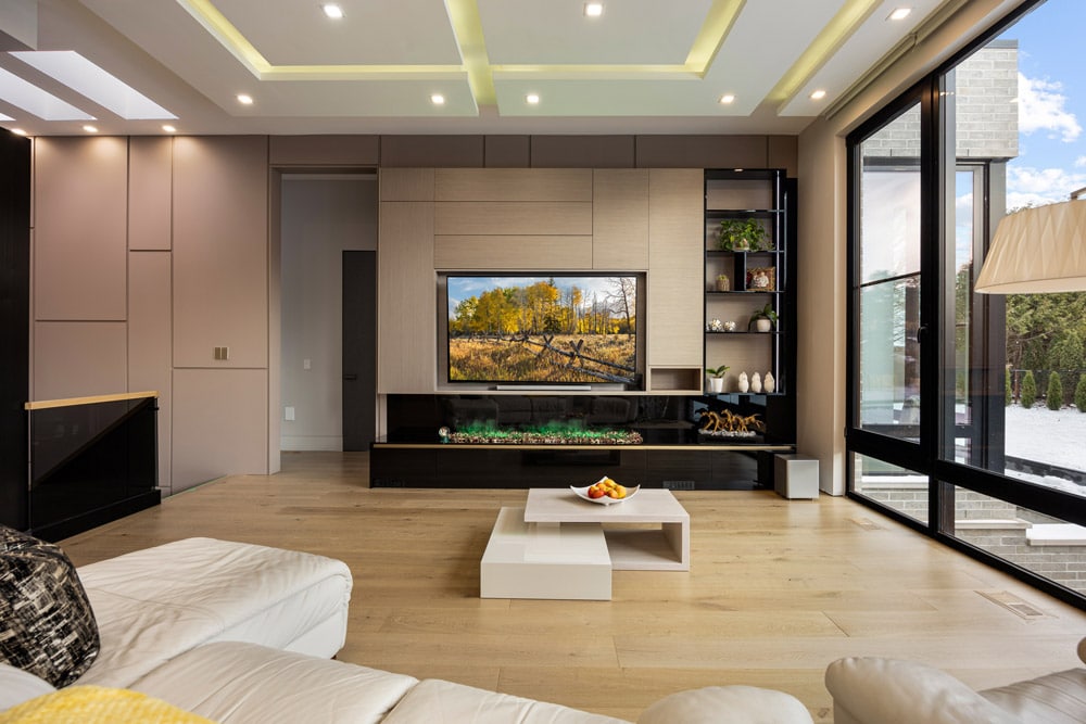 Living room at 27 Farr Ave with coffered LED tray ceiling, fluted oak feature wall, linear fireplace and floor-to-ceiling sliding glass doors