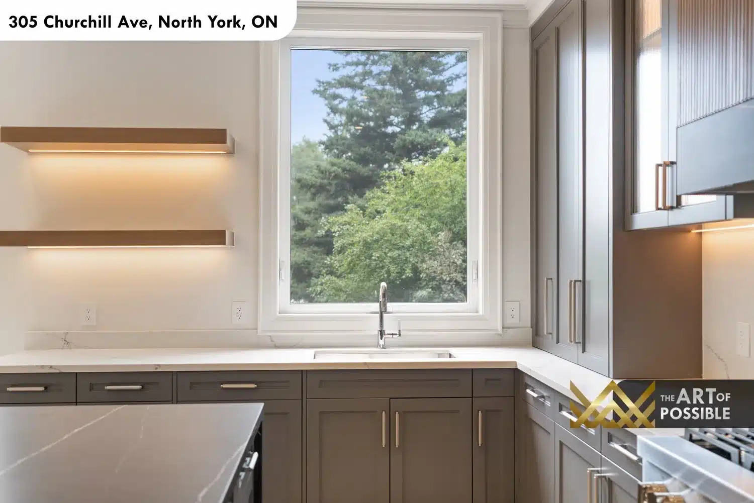 Kitchen sink zone with white quartz countertop, floating wood shelves and large picture window