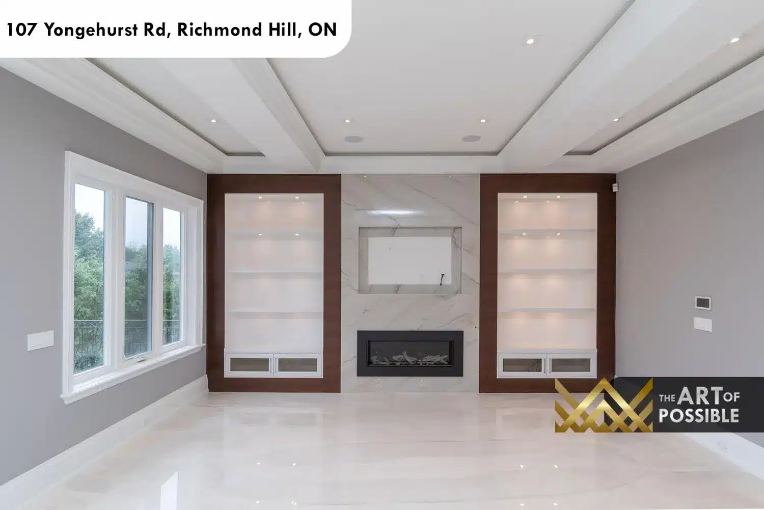Family room with marble tile floors, linear fireplace and walnut-framed white built-in shelving