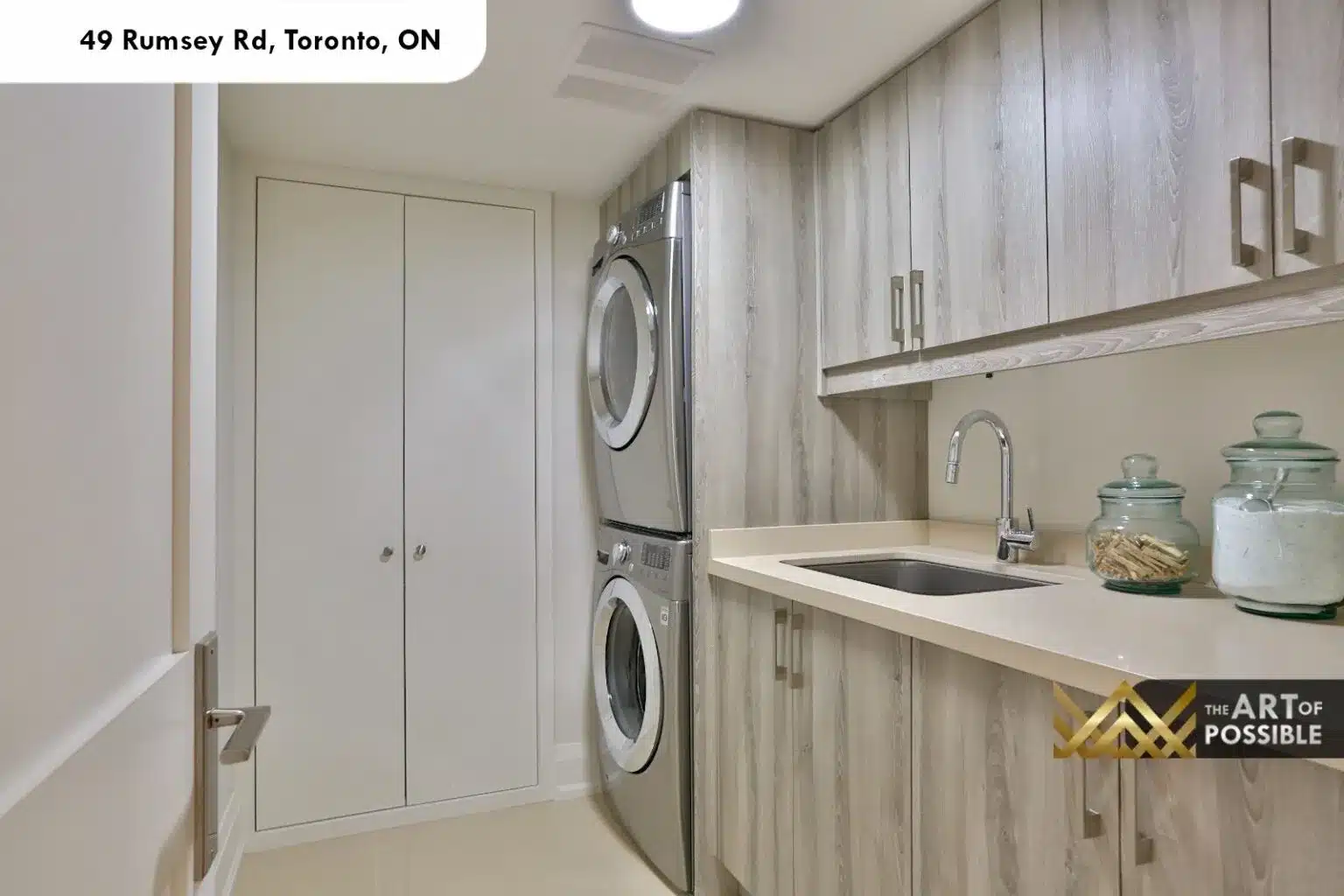 49 Rumsey Rd laundry room stacked washer dryer grey cabinetry quartz countertop