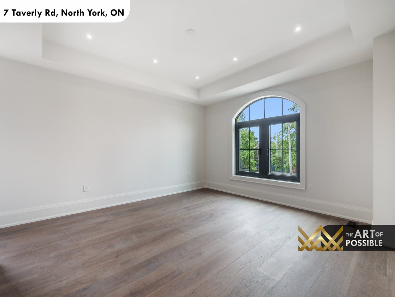 Upper floor bedroom with arched black-framed window