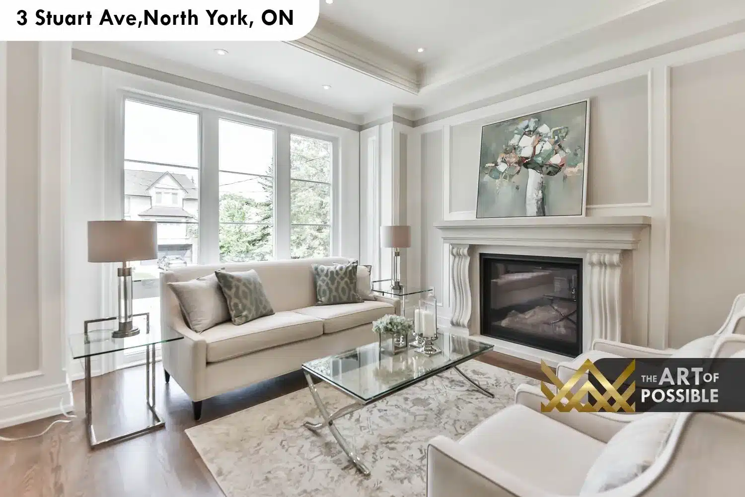 Formal living room with coffered tray ceiling, white carved fireplace surround with reeded columns and floor-to-ceiling windows