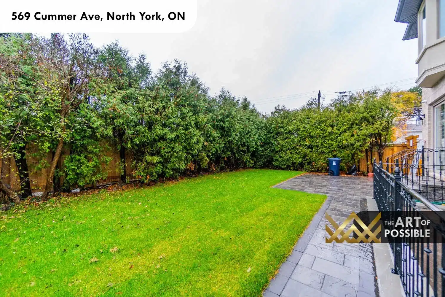 569 Cummer Ave backyard lawn mature hedge cedar fence stone patio exterior