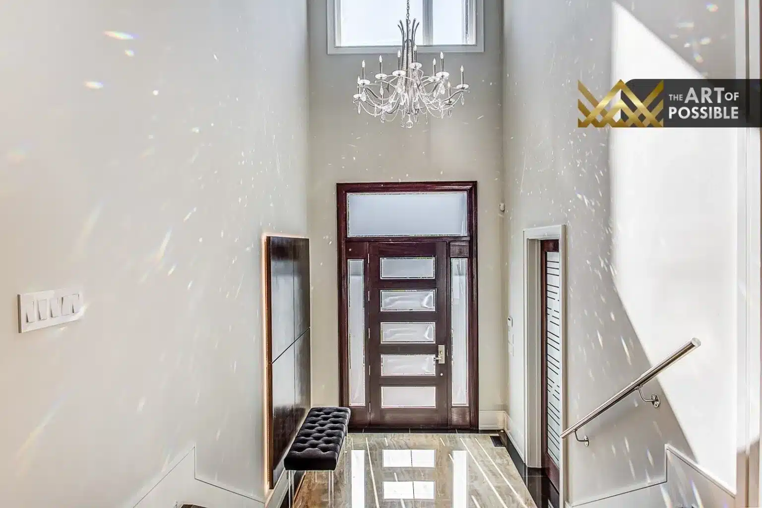 Double-height foyer at 230 Hounslow Ave with crystal chandelier and polished stone floors