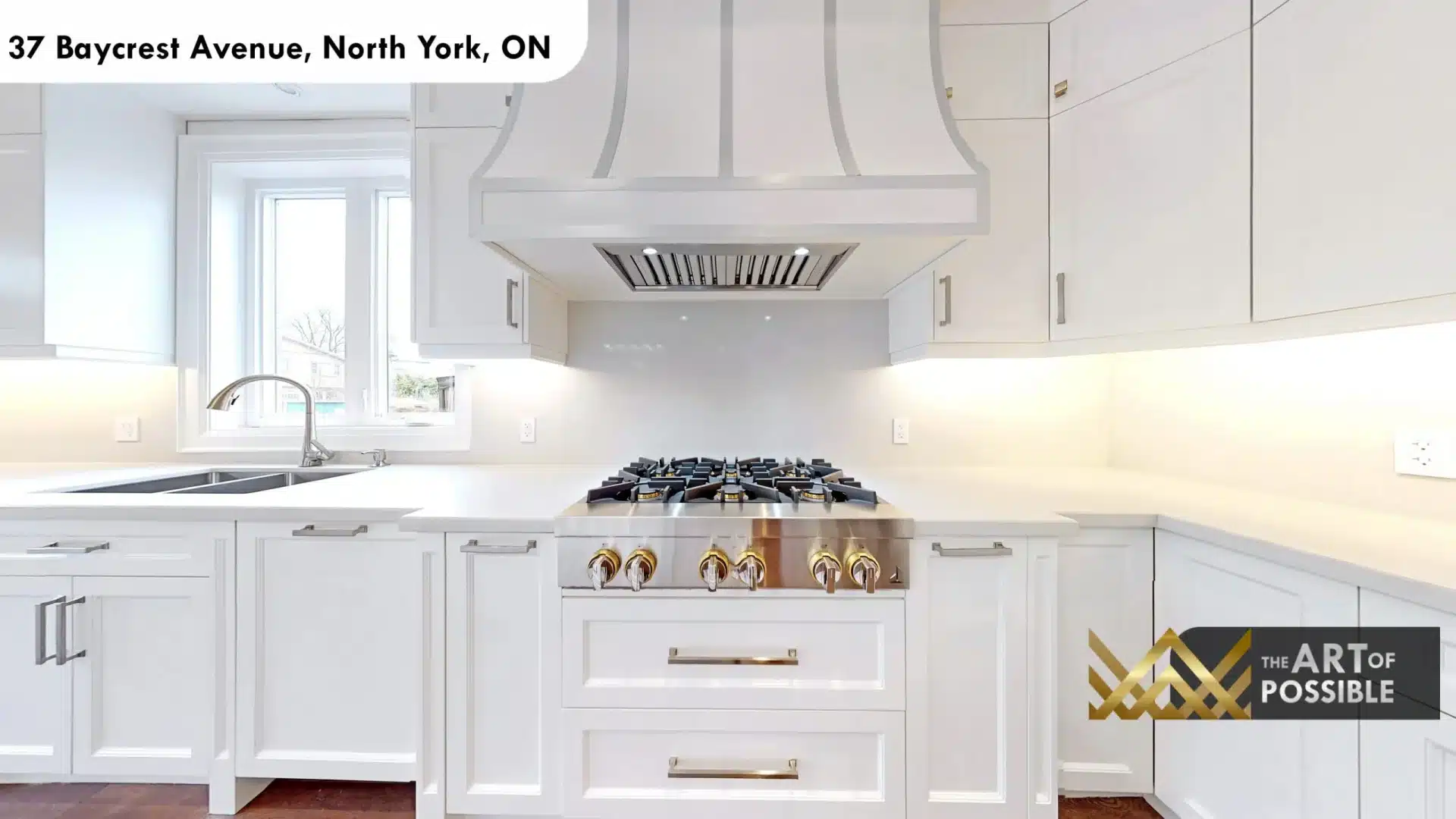 37 Baycrest Ave kitchen detail custom range hood brass knob six burner gas range white cabinetry