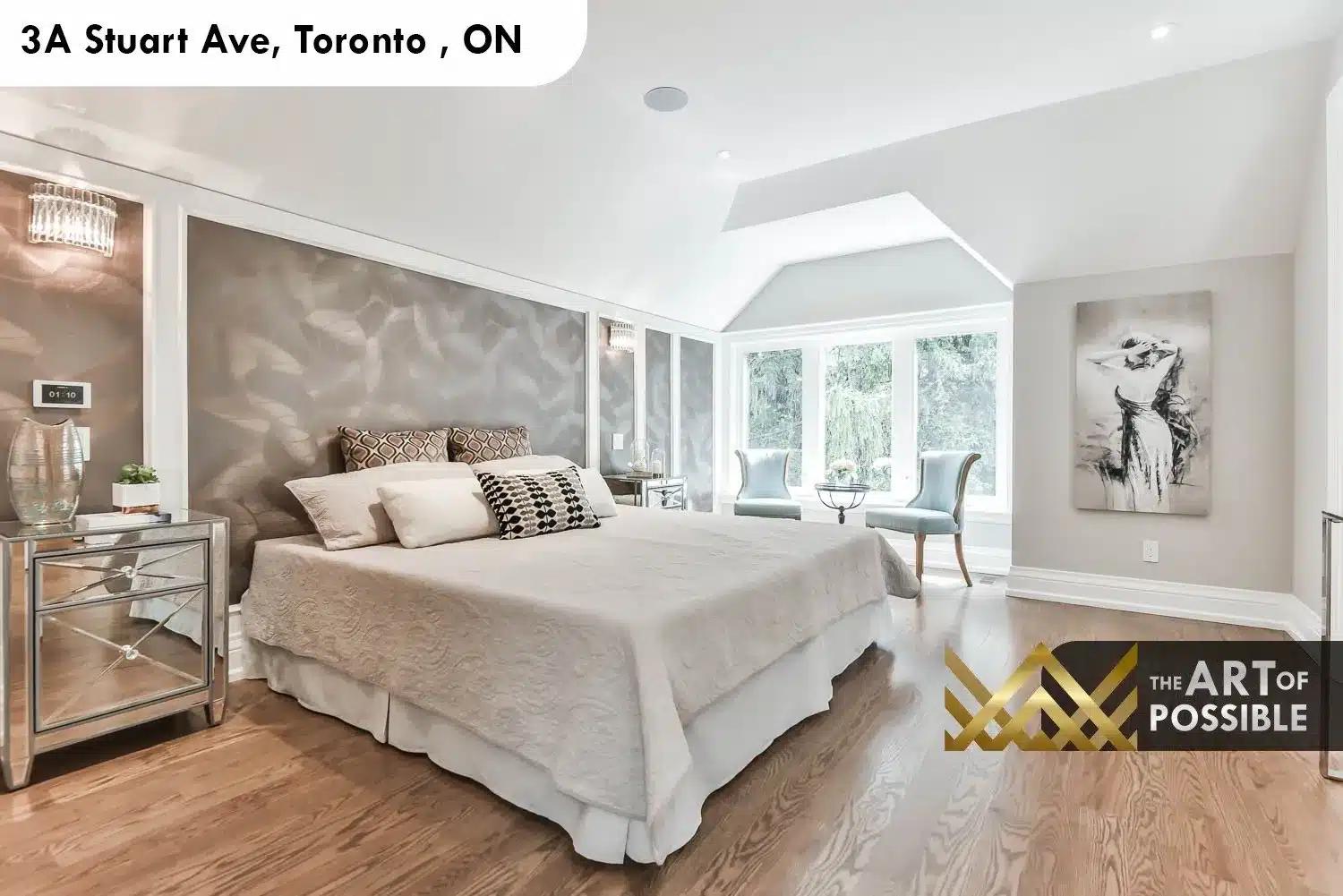 Primary bedroom at 3A Stuart Ave with vaulted dormer ceiling, textured silver accent wall and bay window sitting area