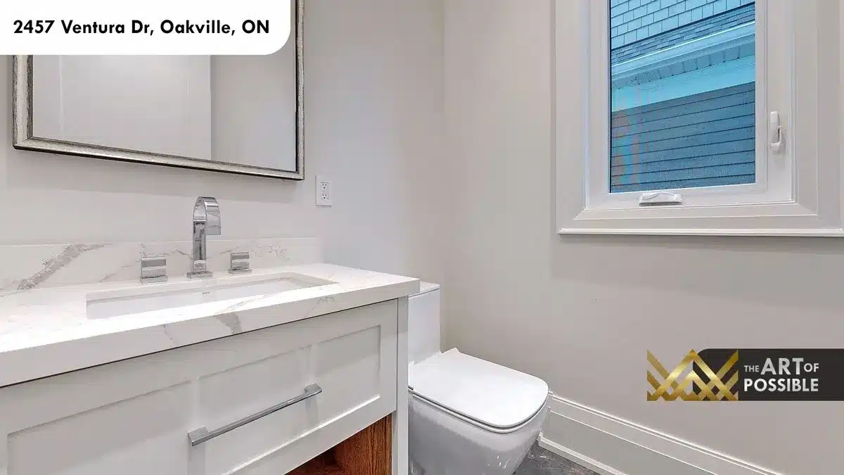 Main floor powder room with white shaker vanity marble countertop and chrome fixtures