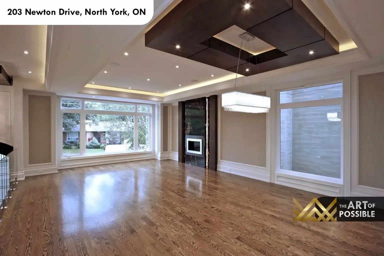 Living and dining area with waffle ceiling, panel moulding and globe chandelier