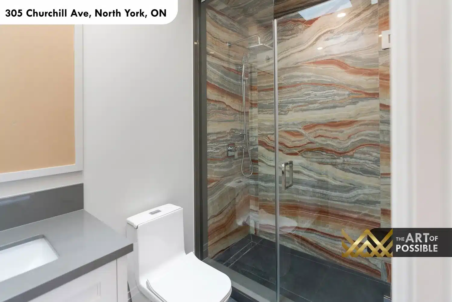 Secondary bathroom walk-in shower with dramatic striated multi-color quartzite surround