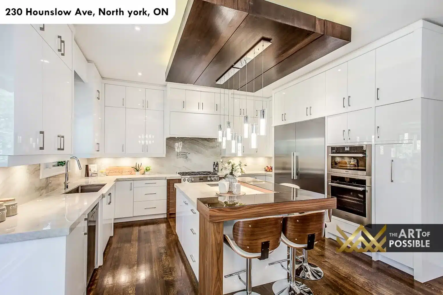 Kitchen at 230 Hounslow Ave with white cabinetry, walnut island and chrome pendant lights