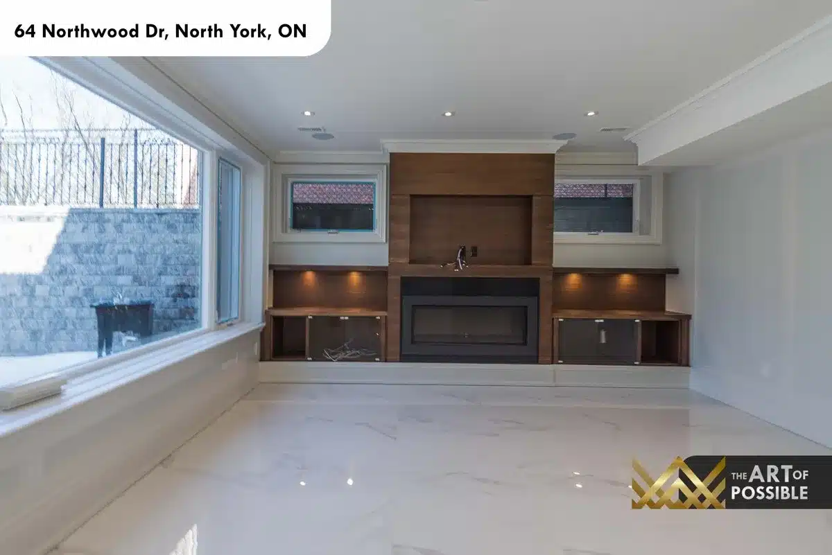 Lower level family room with built-in shelving and fireplace