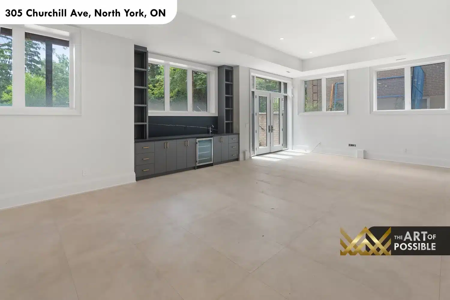 Lower level recreation room full width view showing generous open plan and walk-out French door access