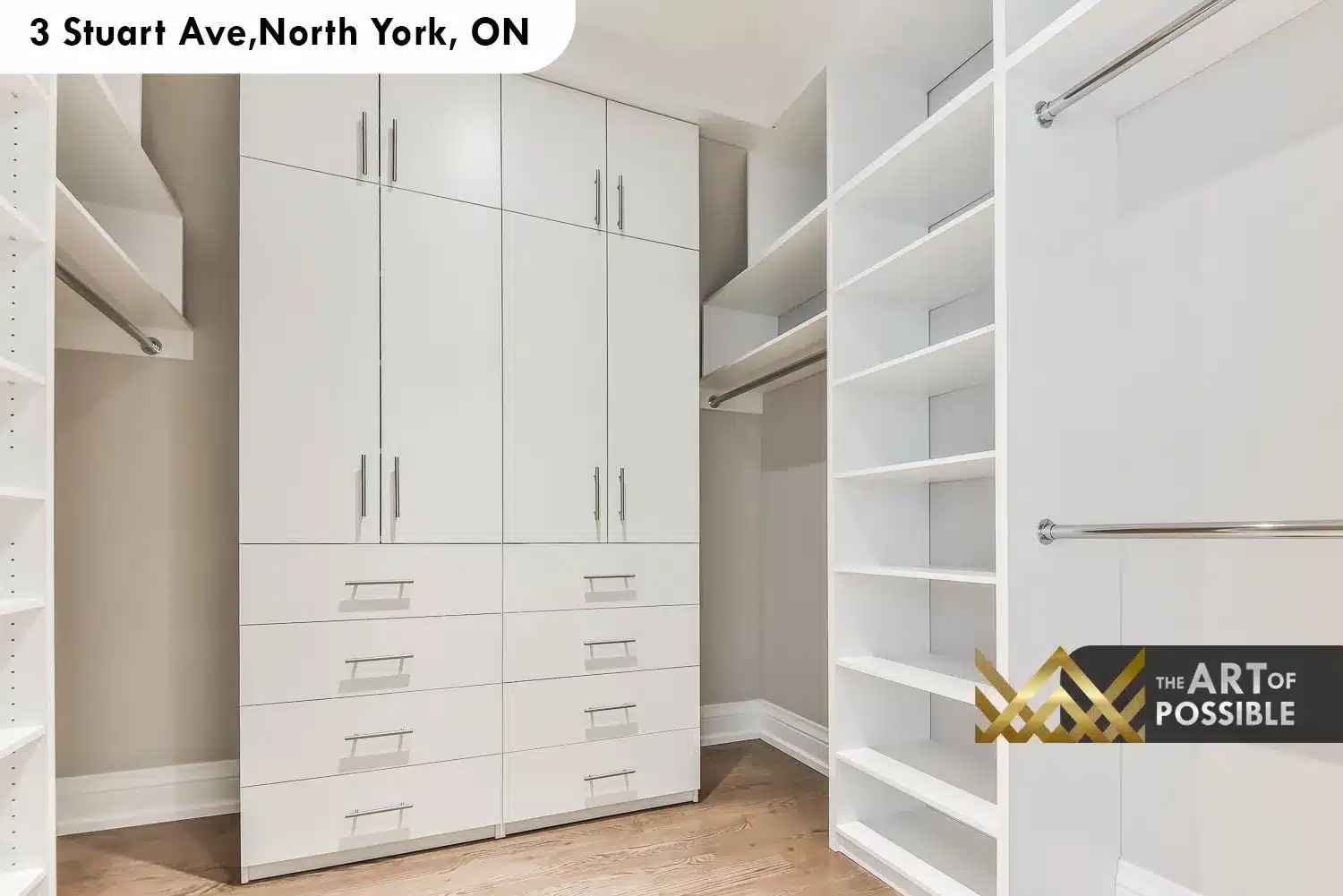 Walk-in closet with white lacquer built-in cabinetry, chrome bar pulls, drawer banks and open shelving