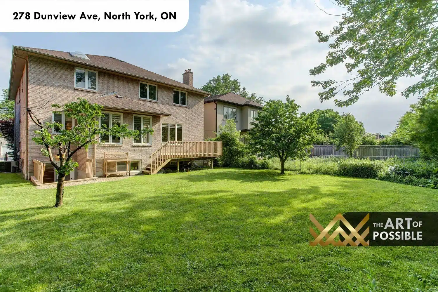 Rear elevation of 278 Dunview Ave showing the raised wood deck and large backyard