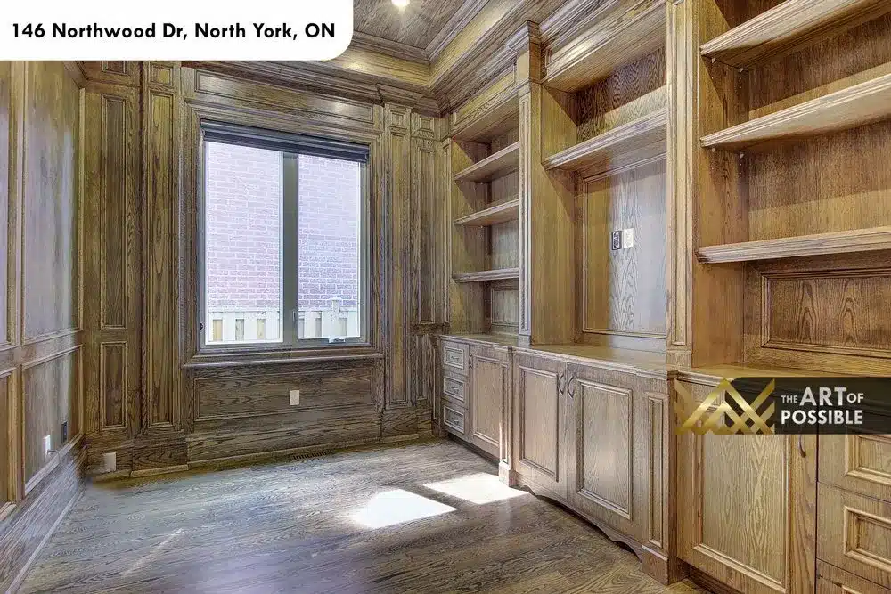 Wood-panelled library with built-in oak shelving at 146 Northwood Dr