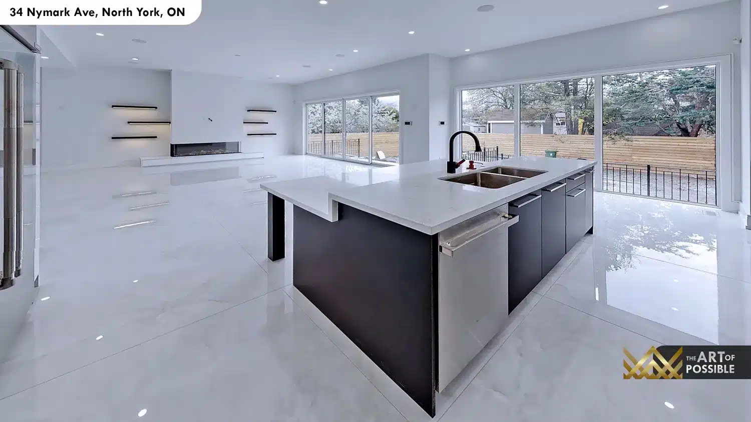 Kitchen island - dark charcoal base with white quartz top, stainless undermount sink and matte black faucet