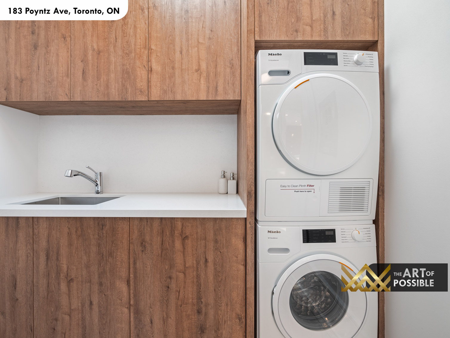 183 Poyntz Ave North York laundry room with Miele stacked washer dryer custom wood cabinetry and white quartz counter