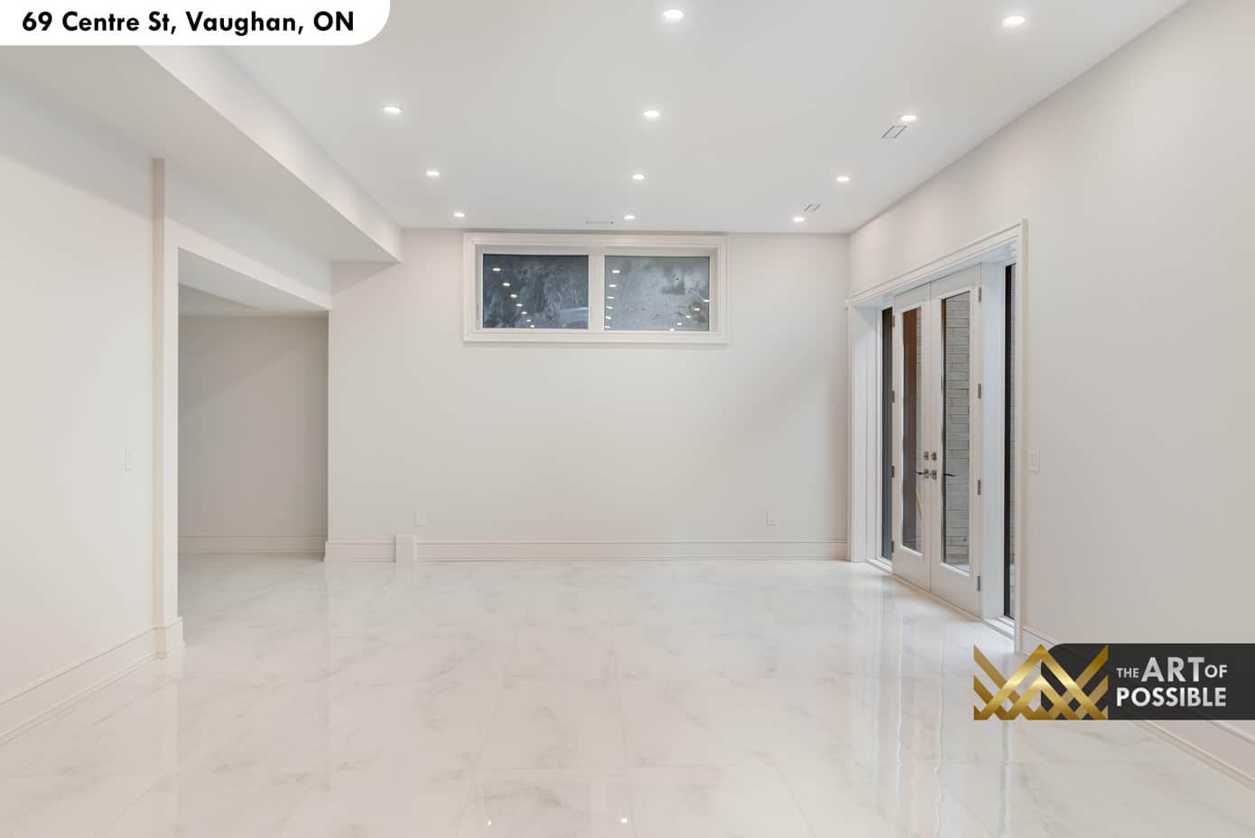 Basement recreation room with polished tile floors and walkout French doors to rear yard