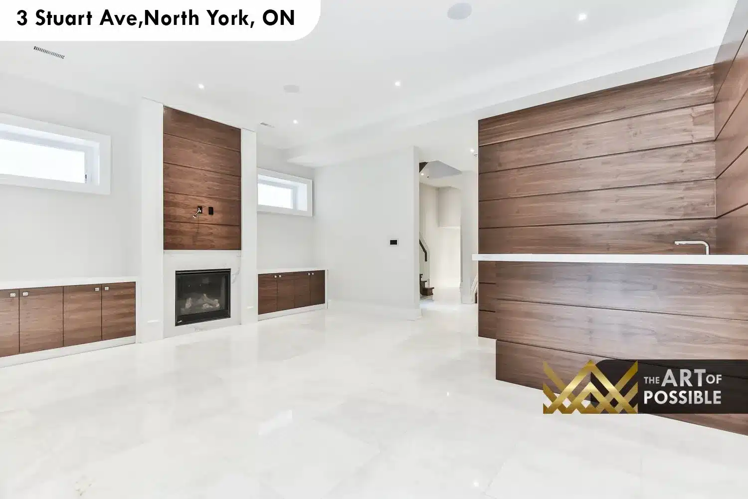 Lower level rec room with polished white porcelain tile floors, walnut horizontal slat feature walls and gas fireplace