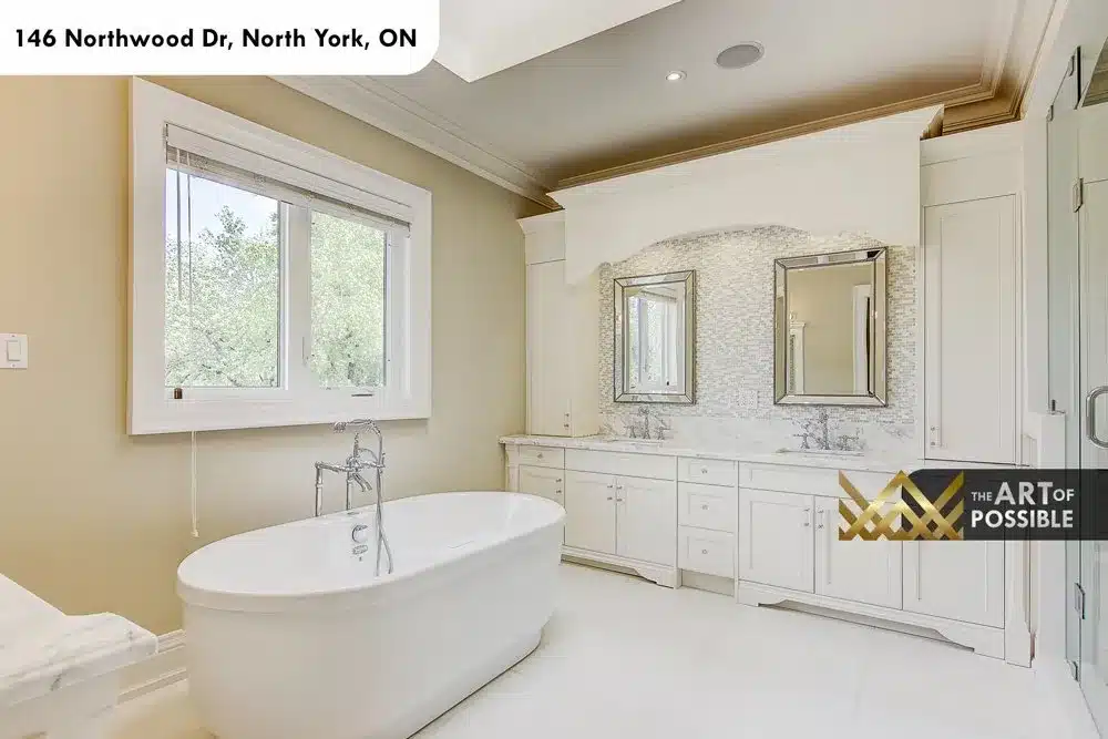 Primary ensuite with freestanding tub, double vanity and mosaic tile